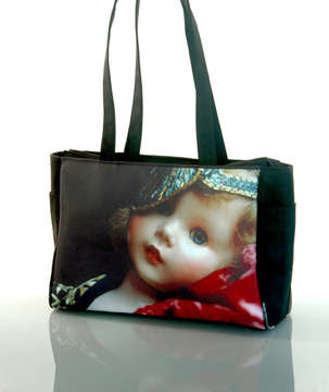 "Daniella the Doll" 
Tote Bag : Two elastic side bottle pockets, interior zipper pocket, zipper closure, water & stain resistant interior. 15.5" x 11" x 5 " at base. 1" x 24" handles