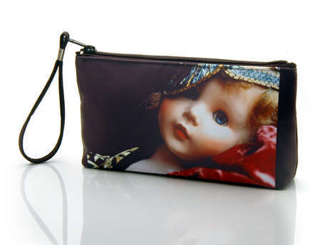 "Daniella the Doll"
Cosmetic/clutch bag with zipper closure, interior attached key fob   10" x 5.5" x 1.75"- at base 6.5" 