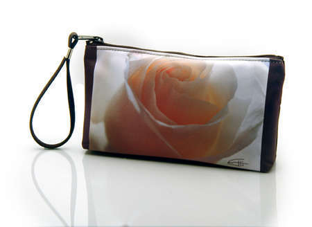 "White Rose"
Cosmetic/clutch bag with zipper closure, interior attached key fob   10" x 5.5" x 1.75"- at base 6.5" 